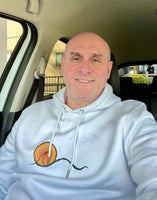 Man wearing white hoodie with line wave and sun graphic.